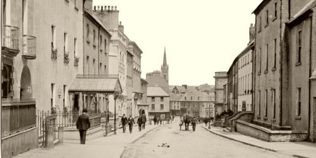 Old postcard of Patrick Street with St Mary's spire