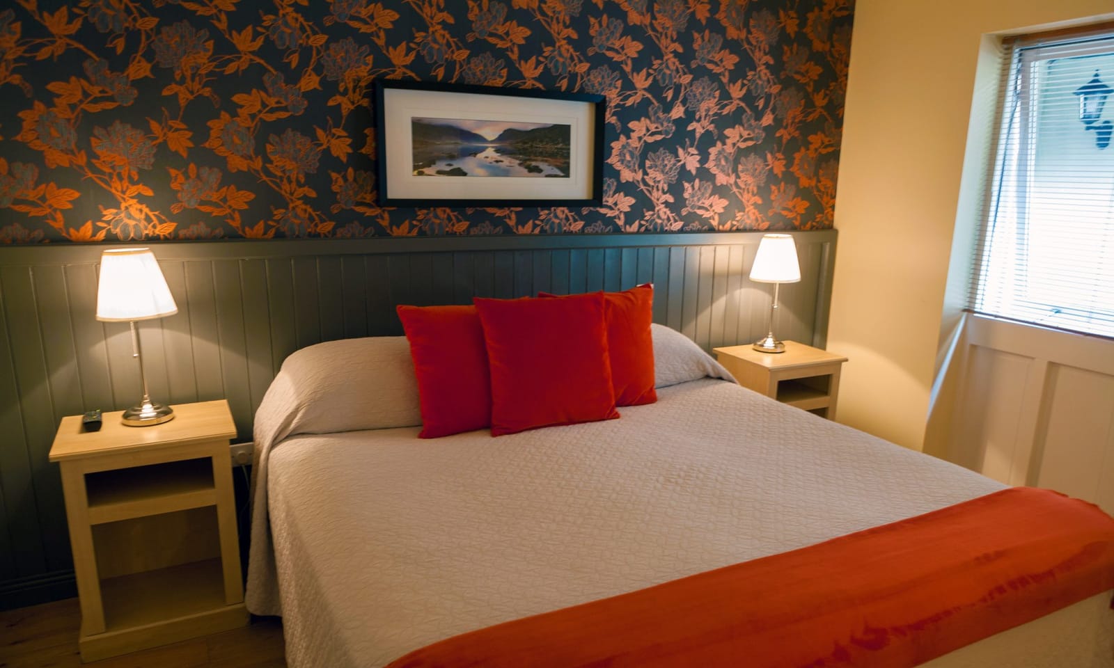 Double room with super-king bed and orange accents